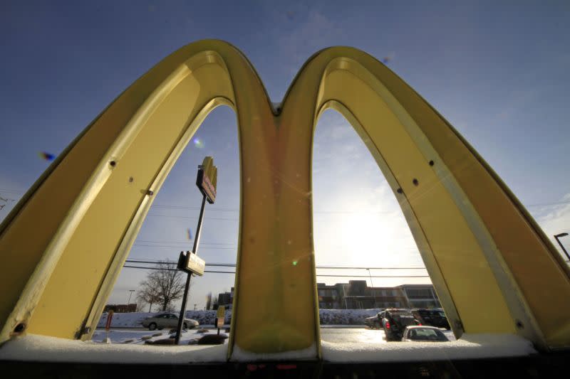 FILE - This Jan. 21, 2014 file photo, cars drive past the McDonald's Golden Arches logo at a McDonald's restaurant in Robinson Township, Pa. McDonaldâ€™s says it will switch to cage-free eggs in the U.S. and Canada over the next decade, marking the latest push under CEO Steve Easterbrook to try and reinvent the Big Mac maker as a â€œmodern, progressive burger company.â€ (AP Photo/Gene J. Puskar, File)