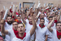 <p>Runners hold up newspapers while they sing to an image of San Fermin before the start of the running of the Jandilla’s fighting bulls during the sixth day of the San Fermin Running of the Bulls festival on July 11, 2017 in Pamplona, Spain. (Gari Garaialde/Getty Images) </p>