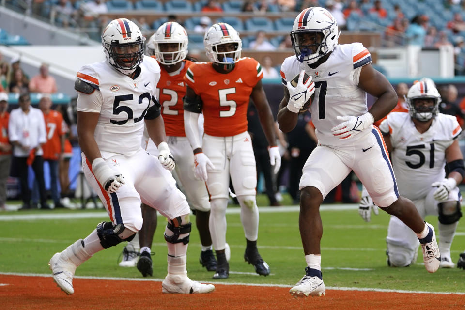 Virginia running back Mike Hollins (7) runs into the end zone to score a touchdown during the first half of an NCAA college football game against Miami, Saturday, Oct. 28, 2023, in Miami Gardens, Fla. (AP Photo/Lynne Sladky)