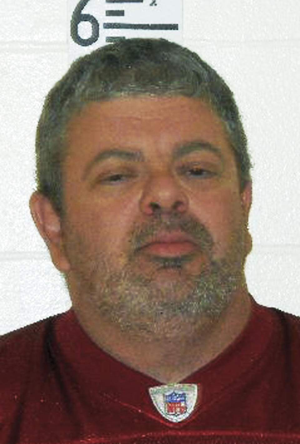 This booking photograph released by the Maine State Police shows Timothy Courtois, who was arrested Sunday, July 22, 2012 on charges of having a concealed weapon and speeding on the Maine Turnpike. Courtois told authorities he was on his way to Derry, N.H., to shoot a former employer. He also said he had attended the Batman movie at the Cinemagic Theater in Saco the previous night. Found in his car were an assault weapon, four handguns and several boxes of ammunition.  A search of his home in Biddeford, Maine, revealed several additional guns, including a machine gun, and thousands of rounds of ammunition.  (AP Photo/Maine State Police)