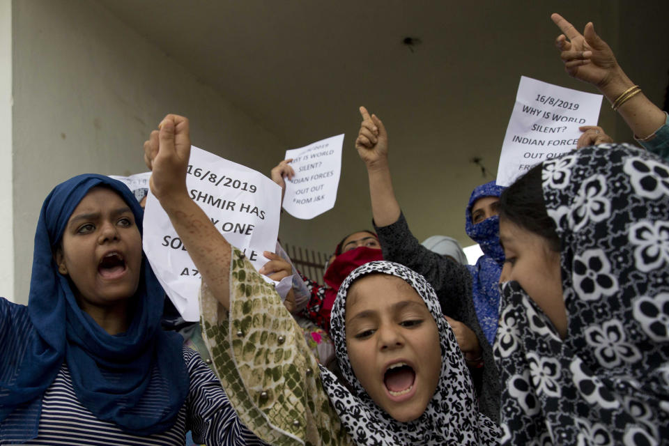 Kashmiri Muslim girls shout pro-freedom slogans during a demonstration after Friday prayers amid curfew like restrictions in Srinagar, India, Friday, Aug. 16, 2019. India's government assured the Supreme Court on Friday that the situation in disputed Kashmir is being reviewed daily and unprecedented security restrictions will be removed over the next few days, an attorney said after the court heard challenges to India's moves.(AP Photo/Dar Yasin)