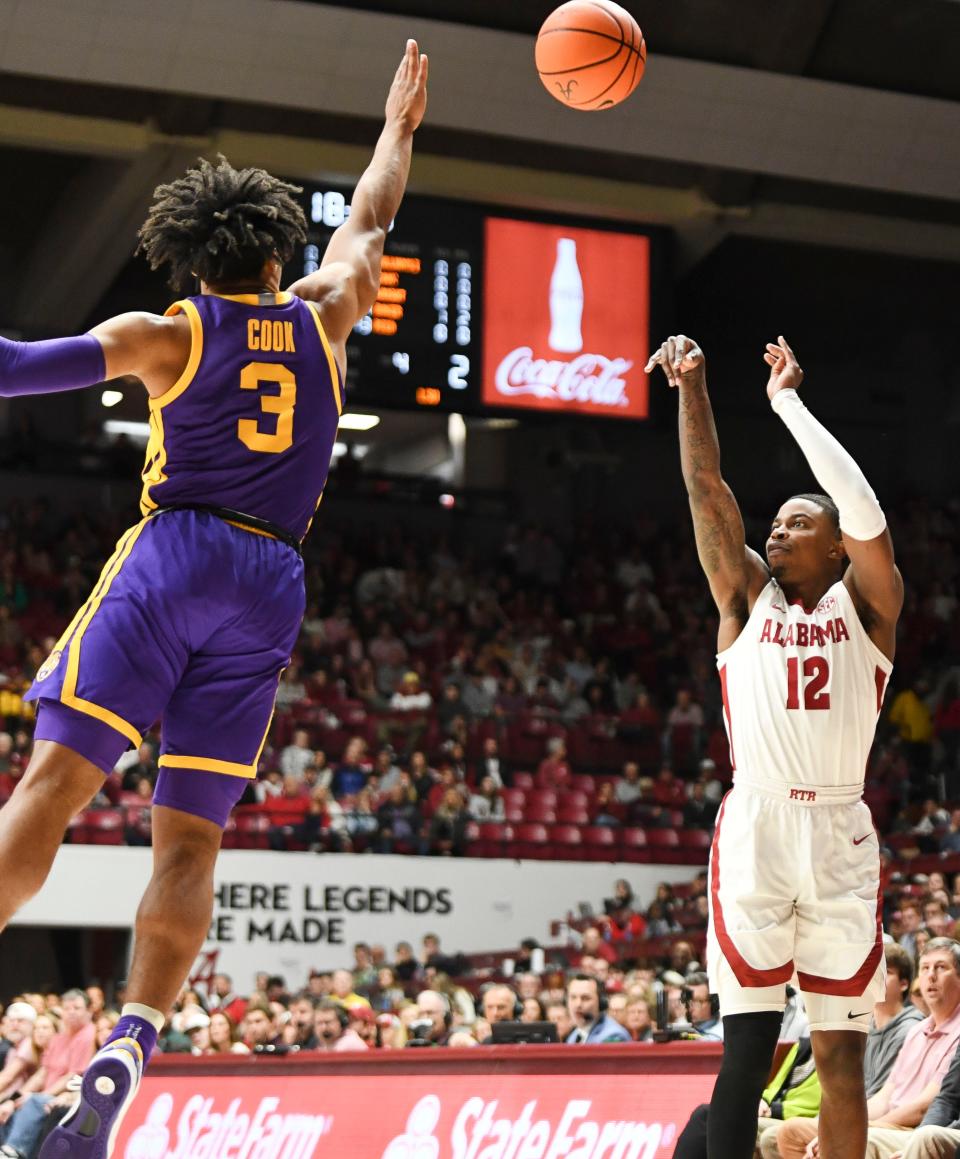 Jan 27, 2024; Tuscaloosa, Alabama, USA; Alabama guard Latrell Wrightsell Jr. (12) takes a three point shot with LSU guard Jalen Cook (3) defending at Coleman Coliseum. Mandatory Credit: Gary Cosby Jr.-USA TODAY Sports