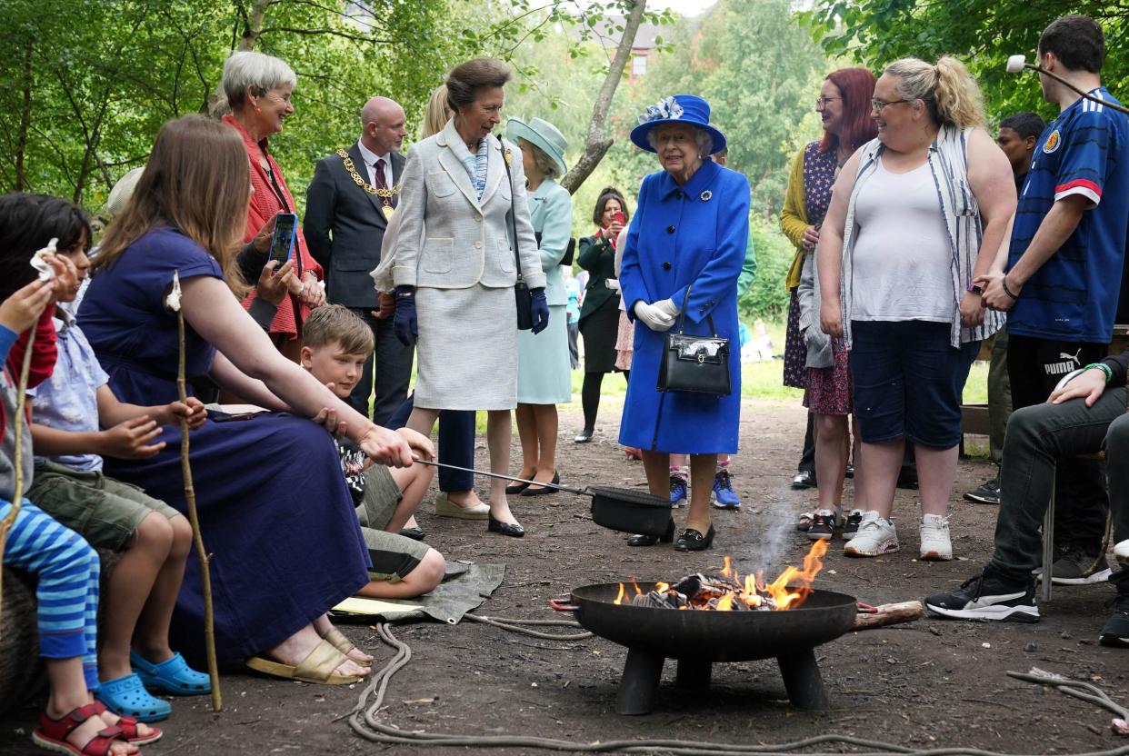 Britain's Queen Elizabeth II and Britain's Princess Anne, Princess Royal meet participants during a visit to The Childrens Wood Project in Glasgow on June 30, 2021, as part of her traditional trip to Scotland for Holyrood Week. (Photo by Andrew Milligan / POOL / AFP) (Photo by ANDREW MILLIGAN/POOL/AFP via Getty Images)