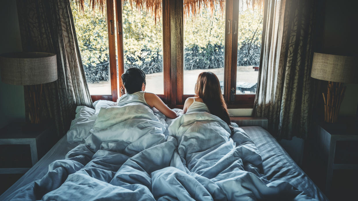Couple love in bed on Holiday time Honeymoon vacation  summer concept.