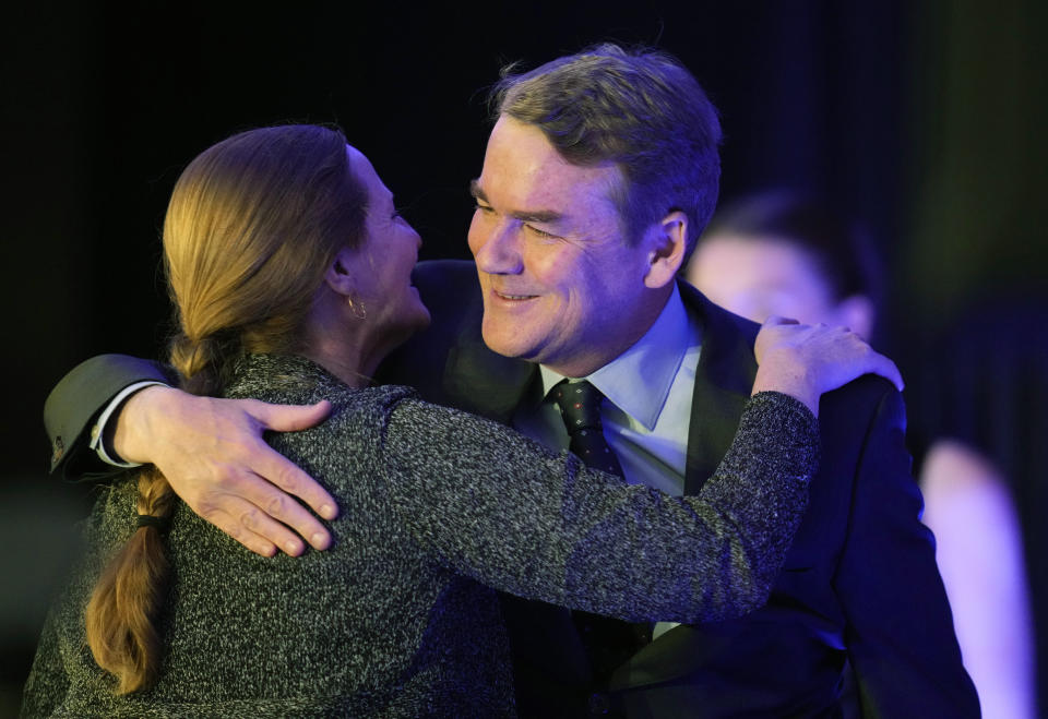 Morgan Carroll, left, Chairperson of the Colorado Democratic Party, welcomes incumbent Sen. Michael Bennet, D-Colo., to speak during an election watch party Tuesday, Nov. 8, 2022, in downtown Denver. (AP Photo/David Zalubowski)