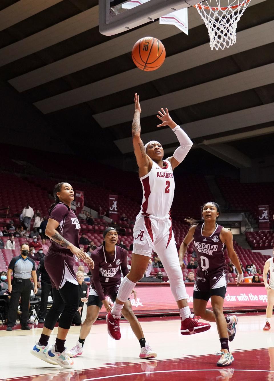 Alabama guard JaMya Mingo-Young (2) loses the ball as she drives through several Mississippi State defenders in Coleman Coliseum Thursday, Jan. 6, 2021.