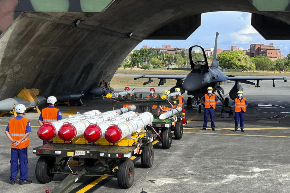 Military personnel stand next to U.S. Harpoon A-84, anti-ship missiles and AIM-120 and AIM-9 air-to-air missiles prepared for a weapon loading drills in front of a U.S. F-16V fighter jet at the Hualien Airbase in Taiwan's southeastern Hualien county, Aug. 17, 2022. The intense firefight over Ukraine has the Pentagon rethinking its weapons stockpiles. If another major war broke out today, would the U.S. have enough ammunition to fight? It’s a question Pentagon planners are grappling with not only as the look to supply Ukraine for a war that could stretch for years, but also as they look to a potential conflict with China. (AP Photo/Johnson Lai, File)