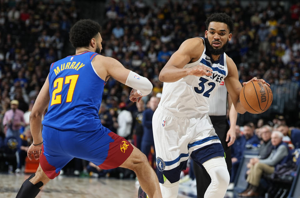 Minnesota Timberwolves center Karl-Anthony Towns, right, drives past Denver Nuggets guard Jamal Murray, left, in the second half of Game 1 of an NBA basketball second-round playoff series Saturday, May 4, 2024, in Denver. (AP Photo/David Zalubowski)