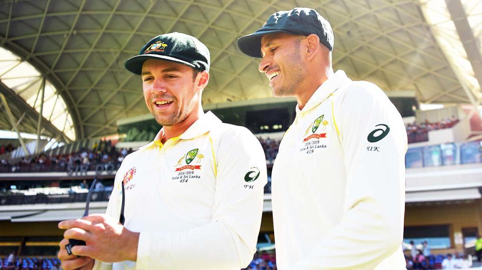 Usman Khawaja (pictured right) and Travis Head (pictured left) walk on to the field.