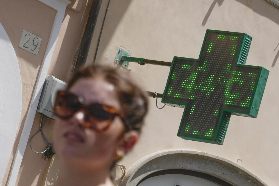 A pharmacy thermometer detects the temperature of 44 degrees Celsius near Spanish Steps in Rome, Tuesday, July 18, 2023. Tourist flock to the eternal city while scorching temperatures grip central Italy with Rome at the top of the red alert list as one of the hottest cities in the country. (AP Photo/Gregorio Borgia)