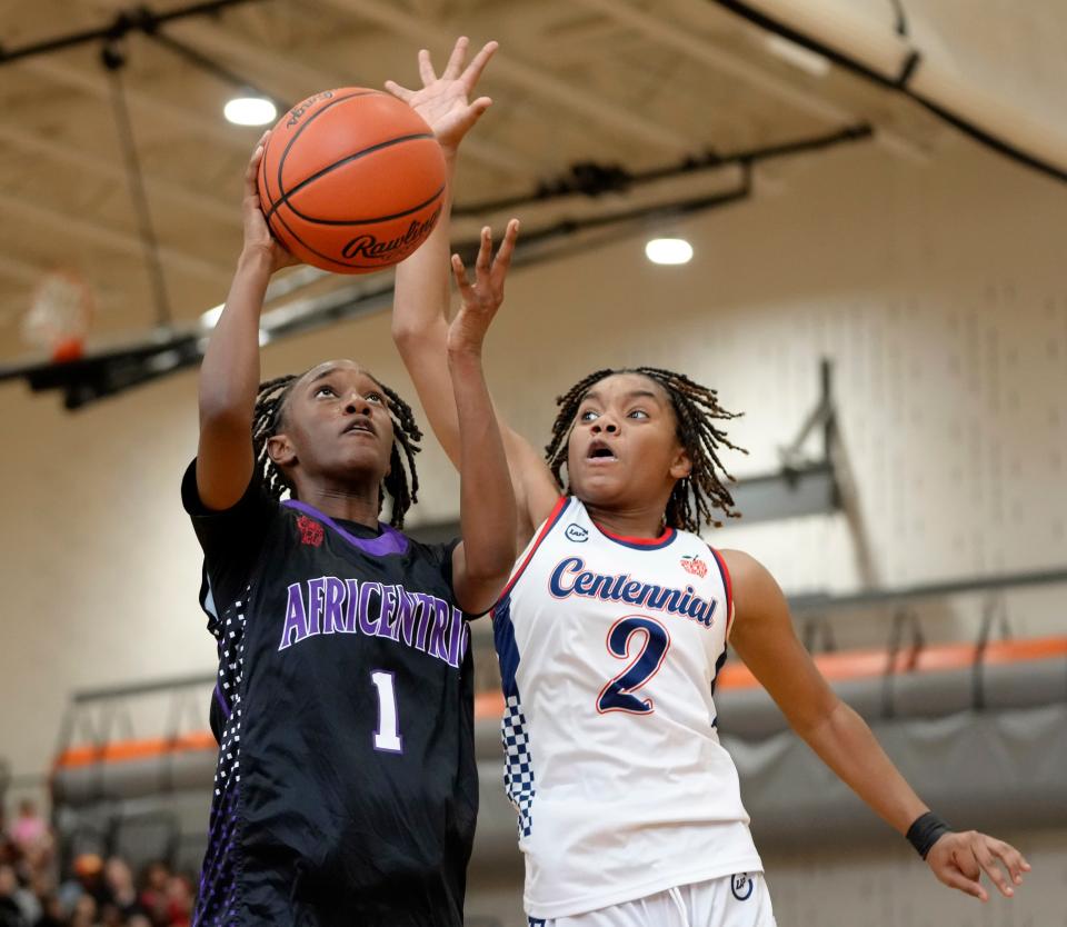 Africentric's Ashtan Winfrey shoots against Centennial's Kennedy Houston during the City League championship game.