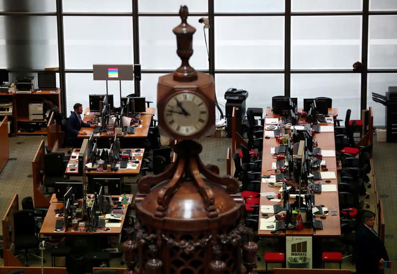 FILE PHOTO: Man works at a desk in the Lloyd's of London building in the City of London financial district