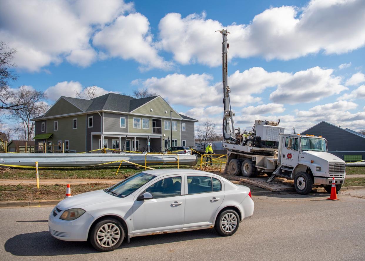 LE Myers Co. employees, contracted by Duke Energy, work on creating new foundations for electric poles along Patterson Drive on Tuesday, March 15, 2023.