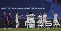 Bayern's Thomas Mueller, right, celebrates with teammates after scoring his sides first goal during the Champions League quarterfinal match between FC Barcelona and Bayern Munich at the Luz stadium in Lisbon, Portugal, Friday, Aug. 14, 2020. (AP Photo/Manu Fernandez/Pool)