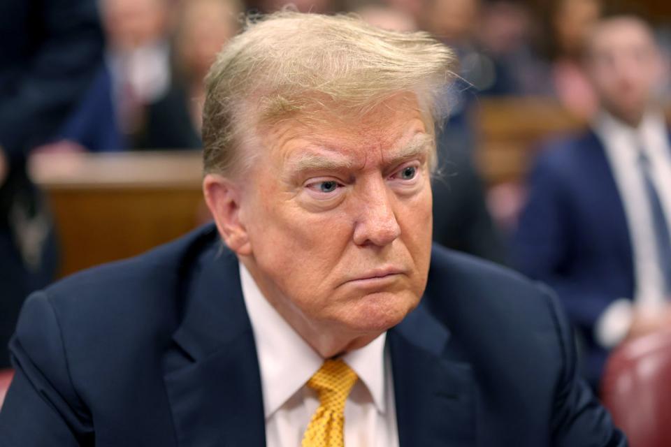 <p>Michael M. Santiago/Getty</p> Donald Trump, pictured in the Manhattan criminal court on May 21, 2024, was charged with 34 felony counts of falsified business records