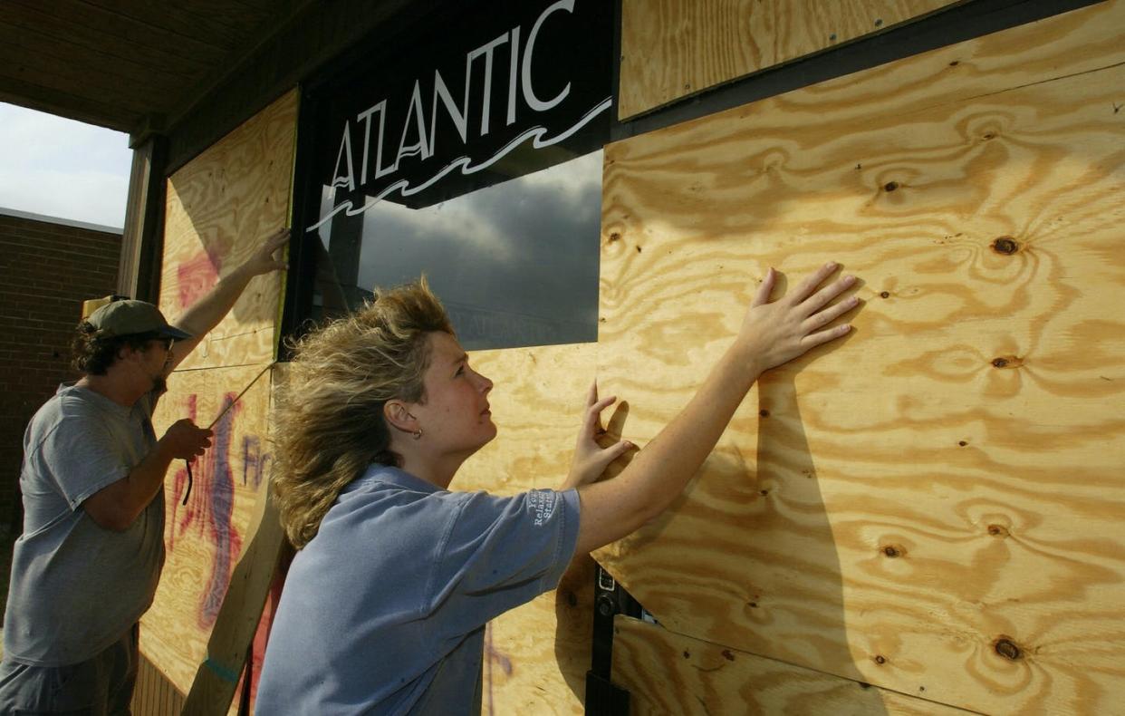 <span class="caption">Preparing for a hurricane on North Carolina's vulnerable Outer Banks.</span> <span class="attribution"><a class="link " href="https://www.gettyimages.com/detail/news-photo/hurricane-veteran-todd-liston-measures-for-plywood-and-news-photo/2500150?adppopup=true" rel="nofollow noopener" target="_blank" data-ylk="slk:Paul J. Richards/AFP via Getty Images;elm:context_link;itc:0;sec:content-canvas">Paul J. Richards/AFP via Getty Images</a></span>