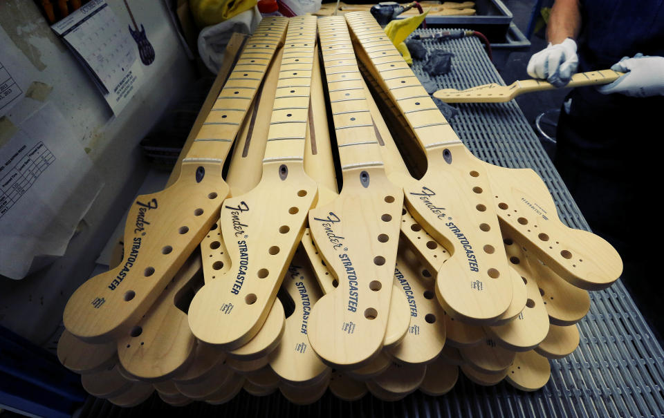 Fender Stratocaster necks are prepared for assembly at the Fender factory in Corona, Calif. on Tuesday, Oct. 15, 2013. The electric guitar, used by countless professional and amateur musicians, celebrates its 60th anniversary in 2014. (AP Photo/Matt York)