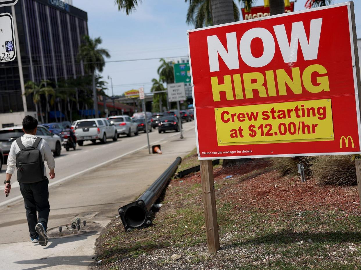 A "Now Hiring" sign