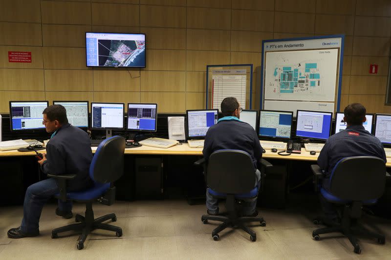 Workers are pictured in a control room at a chlorine-soda plant of the petrochemical company Braskem in Maceio