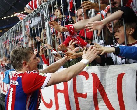 Bayern Munich's Bastian Schweinsteiger celebrates with fans after scoring a goal against Hertha Berlin during their German Bundesliga first division soccer match in Munich April 25, 2015 REUTERS/Kai Pfaffenbach