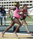 FILE - In this June 26, 2014 file photo, Alysia Montano, foreground, who is 34 weeks pregnant, competes in the quarterfinals of the 800 meter event at the U.S. outdoor track and field championships in Sacramento, Calif. A rebellion led by some of the sport's top runners, Allyson Felix, Kara Goucher and Alysia Montano, is helping change that, and two months after the U.S. women's soccer players stated their case for equal pay, women in athletics are finding footing on an equally important crusade. (AP Photo/Rich Pedroncelli, File)