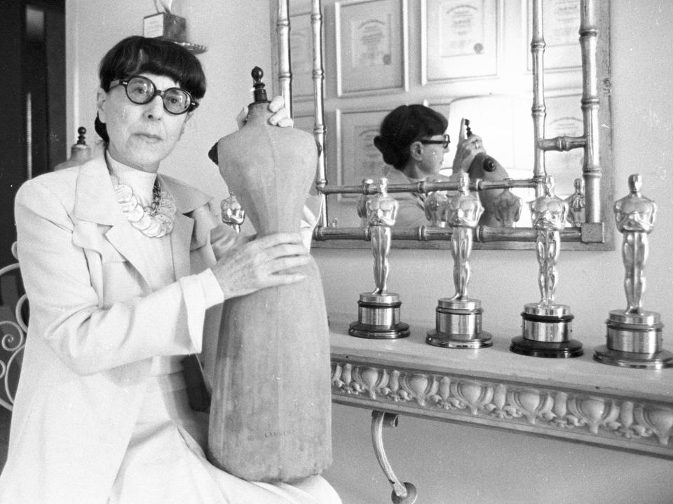 Edith Head poses with some of her eight Academy Awards in 1975.