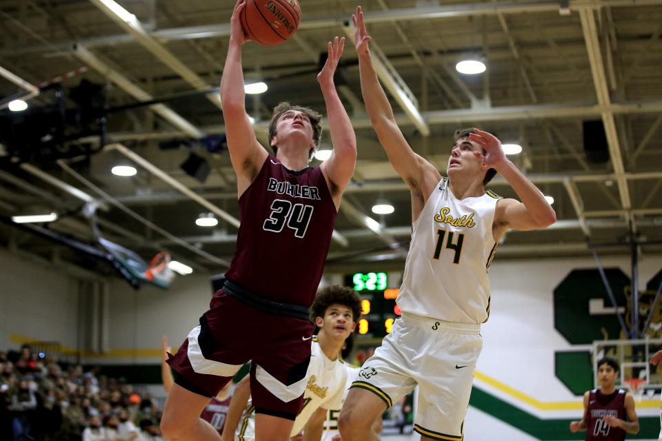 Buhler's Jackson Voth (34) shoots past Salina South's Zach Davidson (14) during their game Tuesday night, Dec. 7, 2021. Buhler defeated Salina South 57-47. Voth was the team's high scorer with 27 points in the game.