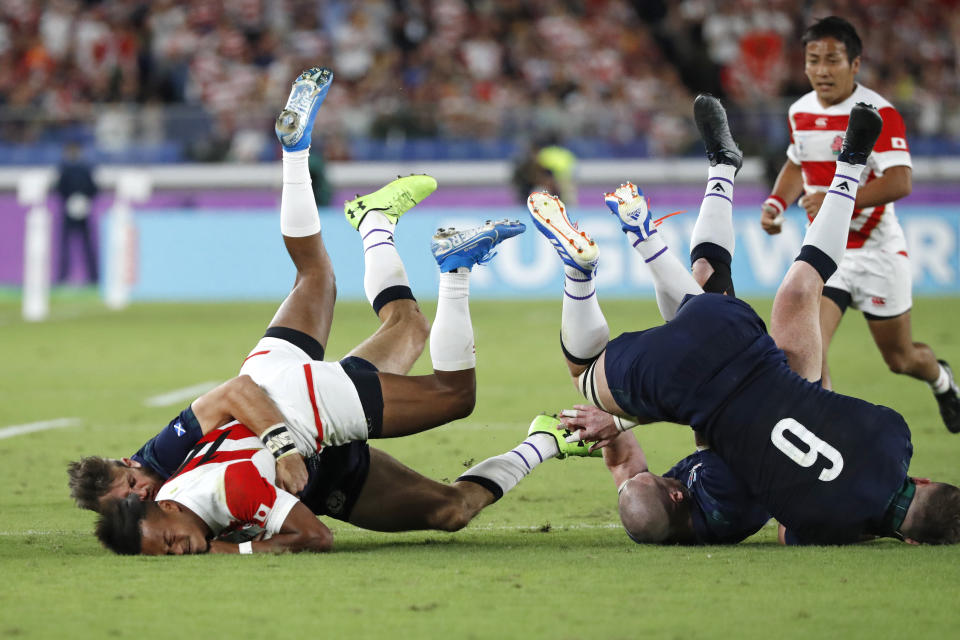 In this Sunday, Oct. 13, 2019, file photo, Japan's Kotaro Matsushima, center left, is tackled by Scotland's defense during the Rugby World Cup Pool A game at International Stadium between Japan and Scotland in Yokohama, Japan. (AP Photo/Eugene Hoshiko, File)