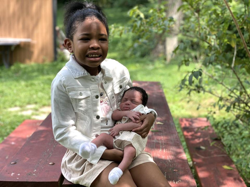 Coleman’s daughters pose for a family portrait at a park.