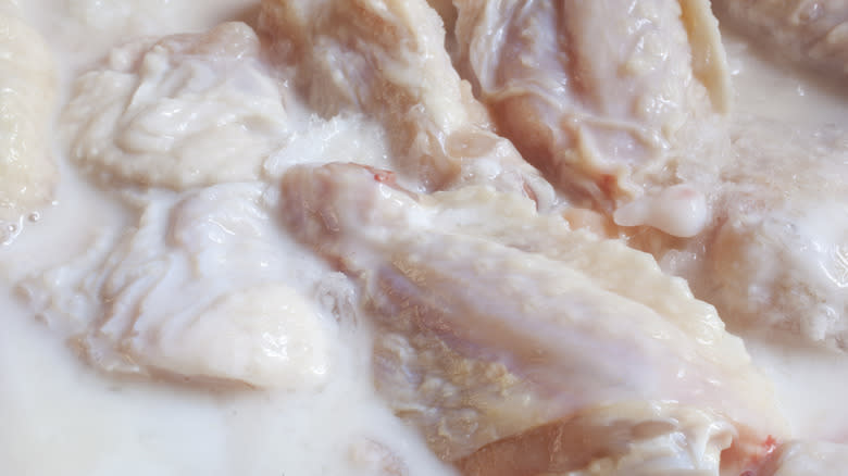 chicken wings marinating in buttermilk