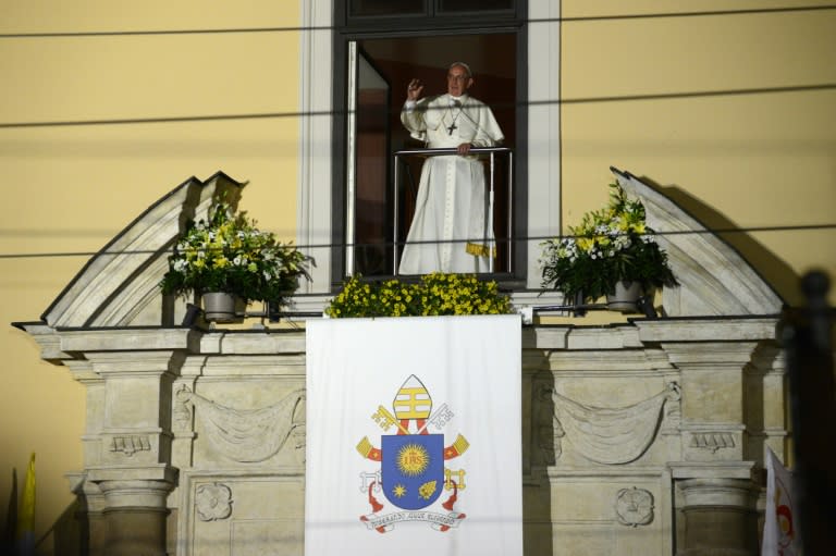 Pope Francis appears in the window of the Archibishop's House in Krakow, on July 27, 2016 as part of his visit for World Youth Day