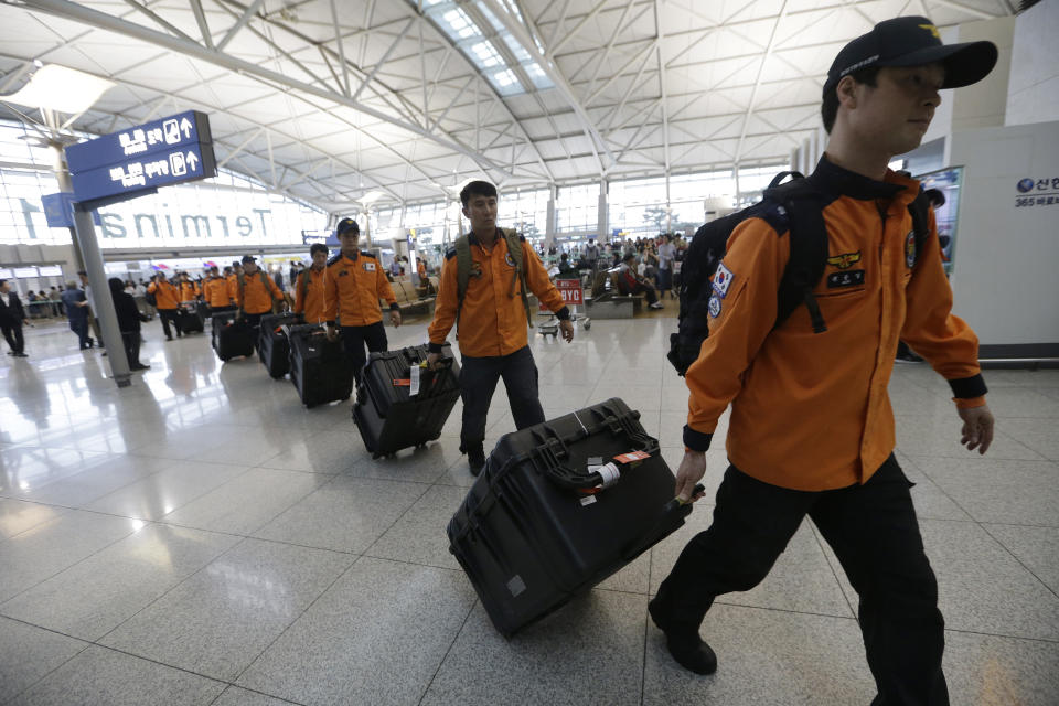 South Korean rescue team members arrive to board a plane to leave for Budapest at Incheon International Airport in Incheon, South Korea, Thursday, May 30, 2019. A massive search is underway on the Danube River in downtown Budapest for over a dozen people missing after a sightseeing boat with 33 South Korean tourists sank after colliding with another vessel during an evening downpour. (AP Photo/Ahn Young-joon)