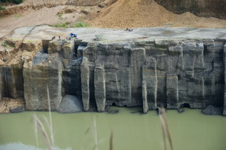 Freelance miners are pictured in October, digging for raw jade stones in piles of waste rubble dumped by mechanical diggers, next to a jade mine in Hpakant, Myanmar