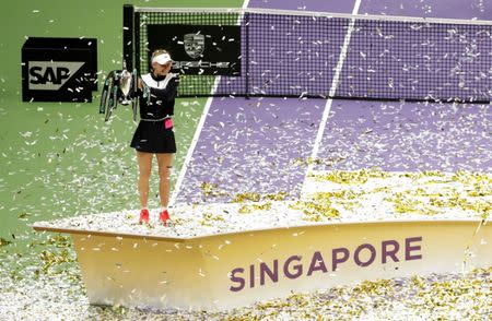 Tennis - WTA Tour Finals - Singapore Indoor Stadium, Singapore - October 29, 2017 Denmark's Caroline Wozniacki celebrates with the trophy after winning the final against USA's Venus Williams REUTERS/Jeremy Lee