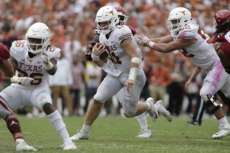 Oct 6, 2018; Dallas, TX, USA; Texas Longhorns quarterback Sam Ehlinger (11) runs the ball against the Oklahoma Sooners in the fourth quarter at the Cotton Bowl. Tim Heitman-USA TODAY Sports
