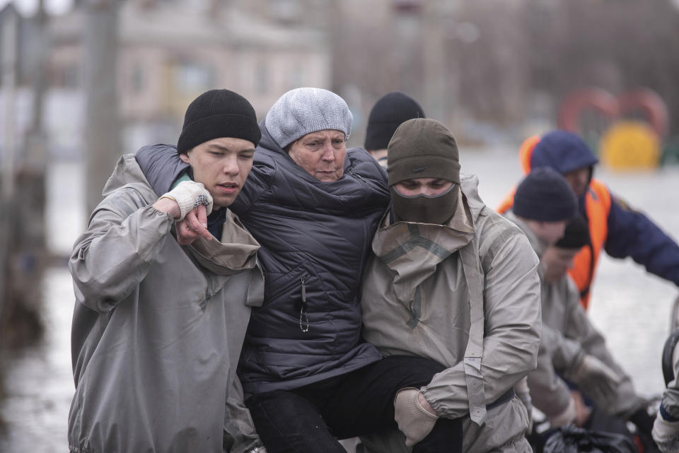 Rescuers carry an elderly woman in a flooded street after a part of a dam burst, in Orsk, Russia on Monday, April 8, 2024. Floods caused by rising water levels in the Ural River broke a dam in a city near Russia's border with Kazakhstan, forcing some 2,000 people to evacuate, local authorities said. The dam broke in the city of Orsk in the Orenburg region, less than 12.4 miles north of the border on Friday night, according to Orsk mayor Vasily Kozupitsa. (AP Photo)