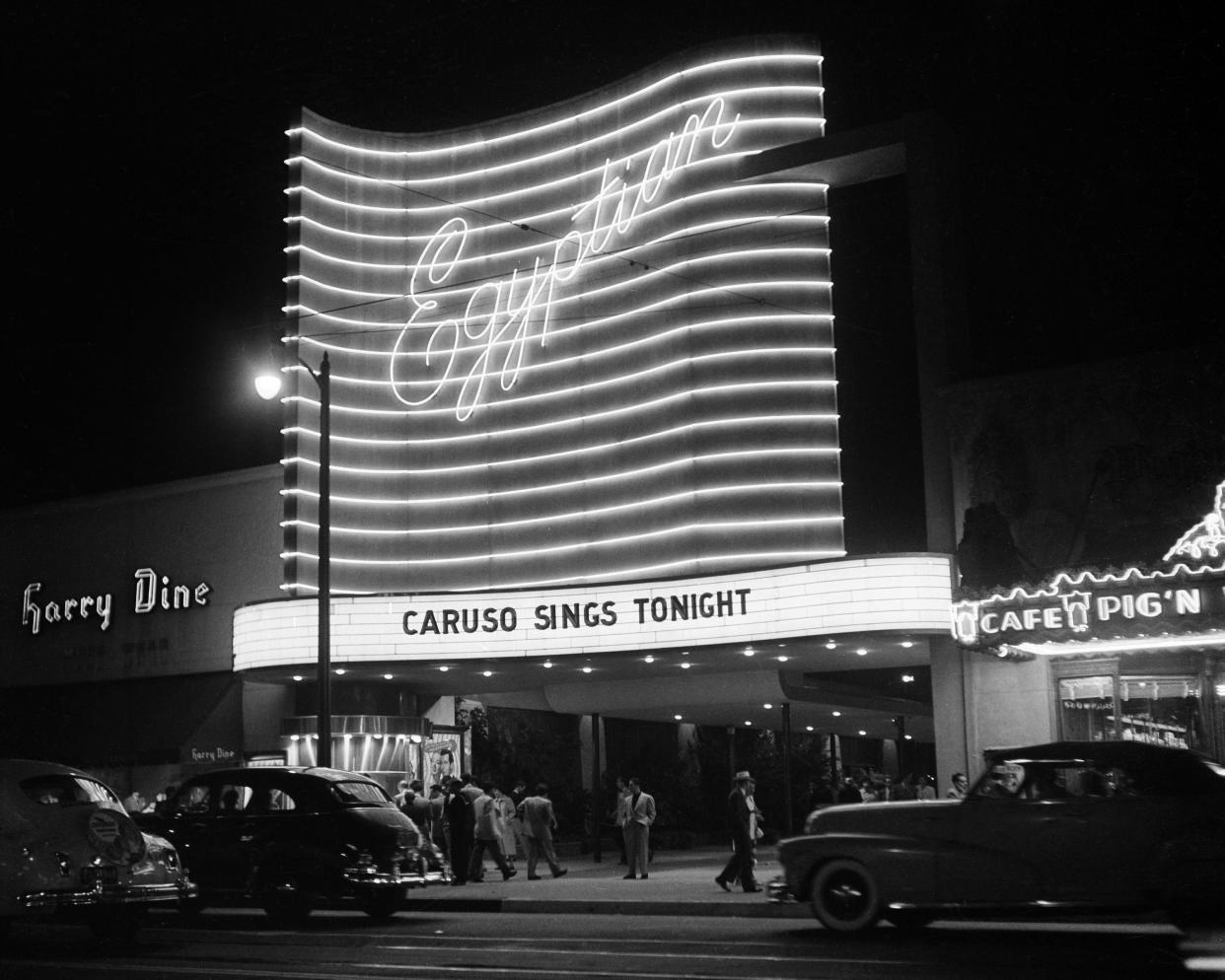 UNE 15,1951: People walk past the Egyptian Theatre on Hollywood Boulevard at night in Hollywood,California