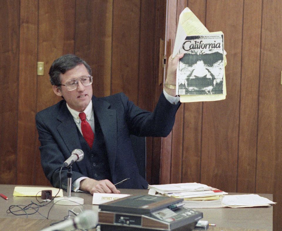 FILE - In this Feb. 9, 1989 file photo, Los Angeles Deputy District Attorney Stephen Kay holds up a magazine profiling convicted murderer Charles Manson while delivering his closing statement at Manson's parole hearing at San Quentin Prison, Calif. Manson was denied parole for the seventh time. Kay was a 27-year-old deputy district attorney just three years out of law school when he joined the prosecution team two months into the Manson Family murders trial. In subsequent years he would attend some 60 parole hearings to argue that the killers never be released from prison, a position that Kay, now in his 70s, still maintains. (AP Photo/Eric Risberg, File)