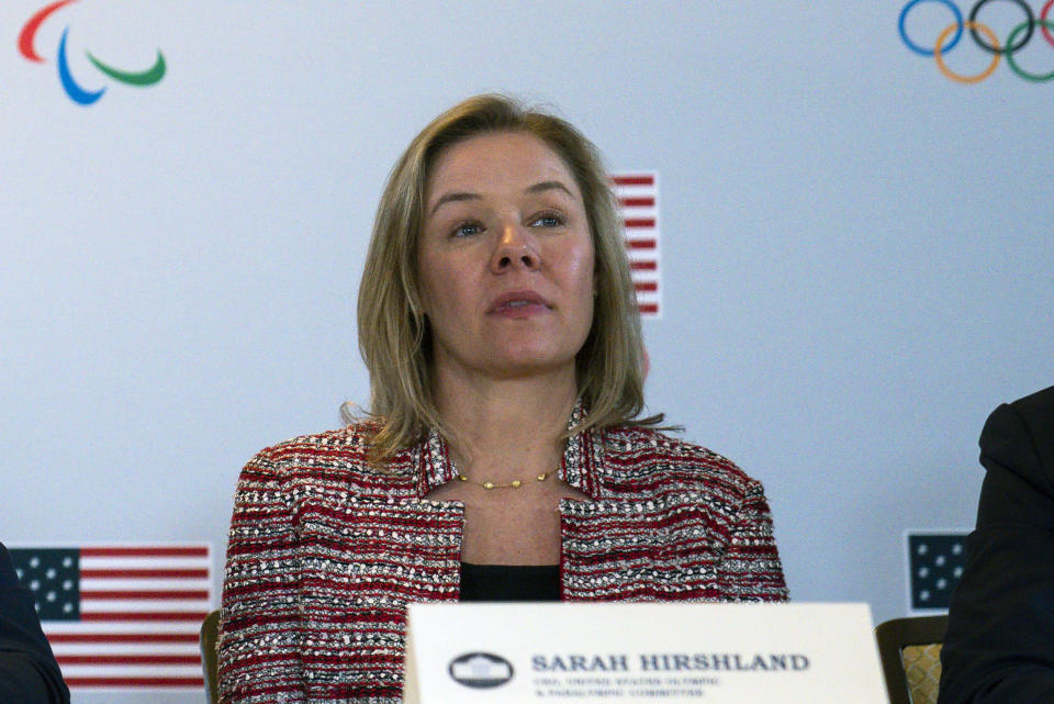 FILE - In this Feb. 18, 2020, file photo, United States Olympic and Paralympic Committee CEO Sarah Hirshland listens as President Donald Trump speaks during a briefing with the U.S. Olympic and Paralympic Committee and Los Angeles 2028 organizers in Beverly Hills, Calif. The U.S. Olympic and Paralympic Committee is signaling willingness to challenge longstanding IOC rules restricting protests at the Olympics, while also facing backlash from some of its own athletes for moves viewed by some as not being driven by sufficient athlete input. (AP Photo/Evan Vucci, File)