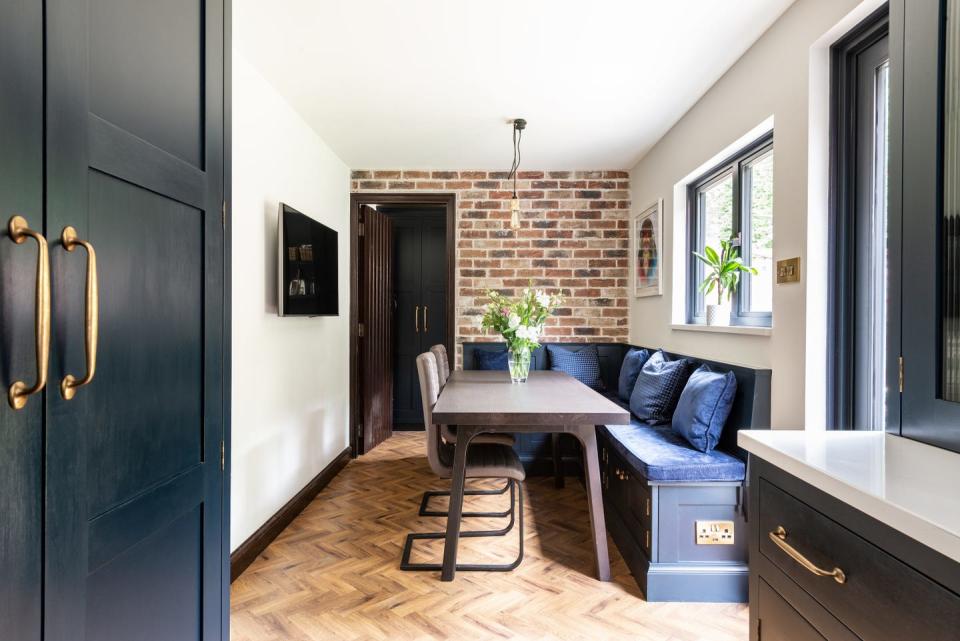 <p>It can be hard to carve out a dining area in a narrow kitchen, but this L-shaped banquette, complete with padding and storage, is the perfect solution. Not only does it reduce the number of chairs needed, it can also double up as a homework station and place to watch TV.</p><p>Pictured: A kitchen project by <a href="https://www.herringbonekitchens.com/" rel="nofollow noopener" target="_blank" data-ylk="slk:Herringbone Kitchens;elm:context_link;itc:0;sec:content-canvas" class="link ">Herringbone Kitchens</a><br></p>
