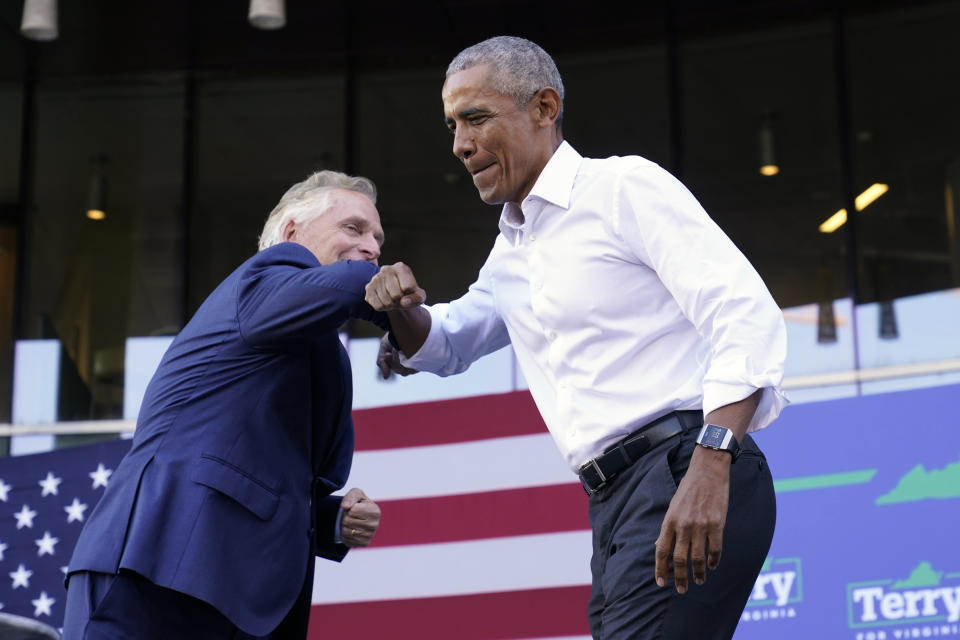 Former President Barack Obama, right, gives an elbow bump to Democratic gubernatorial candidate, former Virginia Gov. Terry McAuliffe during a rally in Richmond, Va., Saturday, Oct. 23, 2021. McAuliffe will face Republican Glenn Youngkin in the November election. (AP Photo/Steve Helber)