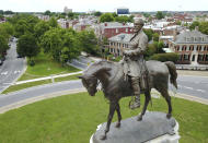 FILE - This Tuesday June 27, 2017 file photo shows the statue of Confederate General Robert E. Lee that stands in the middle of a traffic circle on Monument Avenue in Richmond, Va. Many of the Confederate monuments scattered around the state could soon be coming down after new legislation passed the Virginia legislature. (AP Photo/Steve Helber)