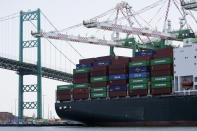 FILE - In this June 19, 2019, file photo a cargo ship is docked at the Port of Los Angeles in Los Angeles. On Wednesday, Nov. 27, the Commerce Department issues the second estimate of how the U.S. economy performed in the July-September quarter. (AP Photo/Marcio Jose Sanchez, File)