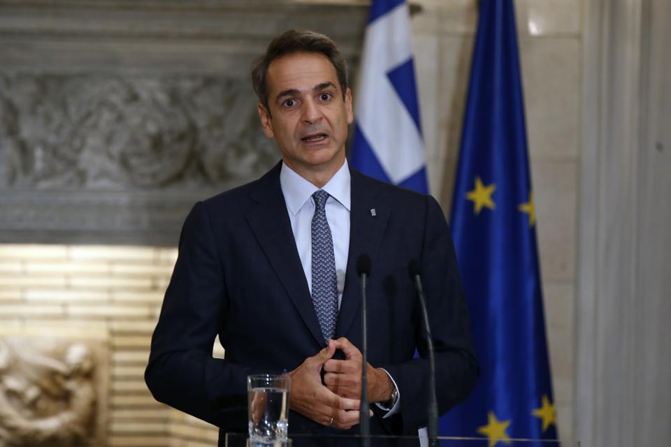 Greece's Prime Minister Kyriakos Mitsotakis makes statements after his meeting with European Council President Charles Michel at Maximos Mansion in Athens, Tuesday, Sept. 15, 2020. Michel will visit Lesbos later today as Greece's migration minister says the government will use force if necessary to move homeless migrants to a new facility on the island after thousands of people were left without shelter by fires last week at an overcrowded refugee camp. (AP Photo/Thanassis Stavrakis)