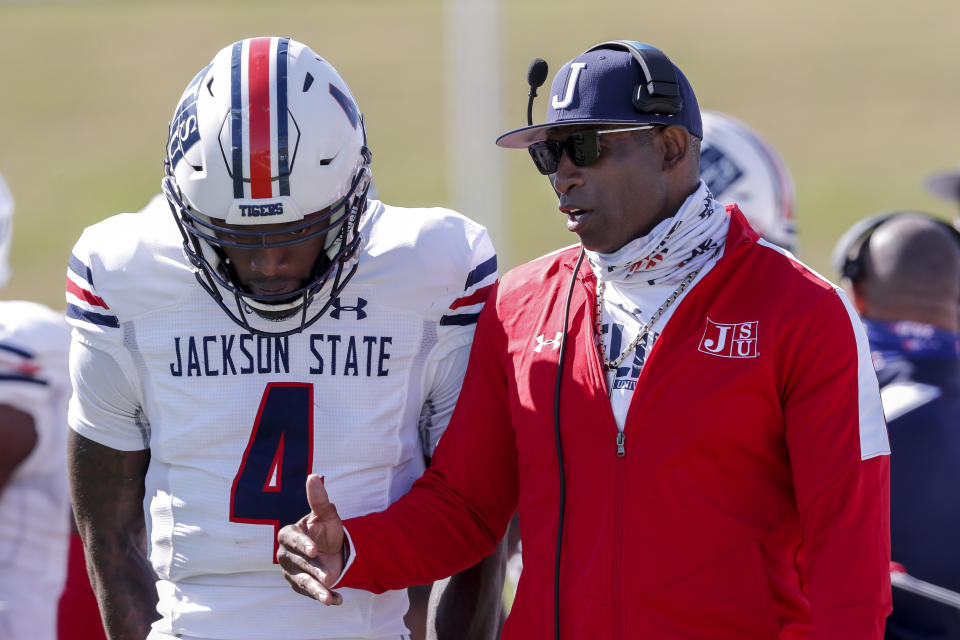 Jackson State coach Deion Sanders talks with his quarterback Jalon Jones during a game last March. (Photo by Don Juan Moore/Getty Images)