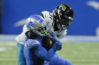 Detroit Lions wide receiver Kalif Raymond (11) is tackled by Jacksonville Jaguars cornerback Darious Williams during the first half of an NFL football game, Sunday, Dec. 4, 2022, in Detroit. (AP Photo/Duane Burleson)