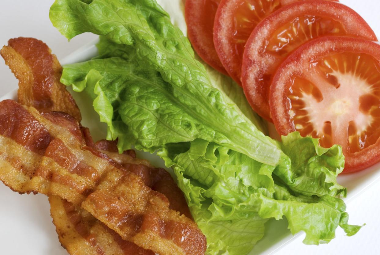 Cooked bacon, green leaf lettuce, and sliced tomato