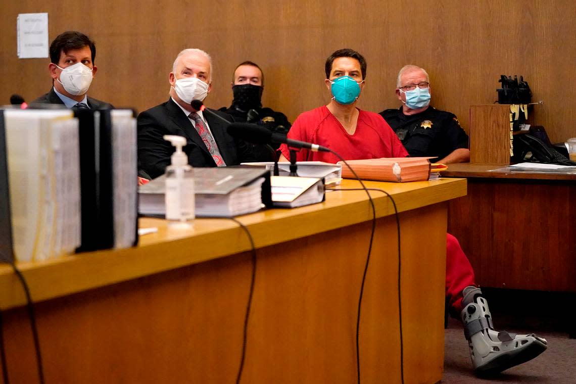 Scott Peterson, foreground right, sits with his attorneys, Andras Farkas, left, and Pat Harris, second from left, at the San Mateo County Superior Court in Redwood City, Calif., Thursday, Aug. 11, 2022. Peterson is in court for a hearing to determine whether he gets a new trial in the murder of his pregnant wife because of juror misconduct. (AP Photo/Jeff Chiu, Pool)