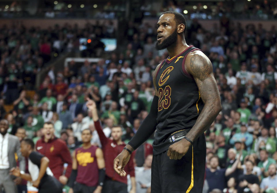 FILE - In this May 27, 2018 file photo, Cleveland Cavaliers forward LeBron James celebrates a basket against the Boston Celtics during the second half in Game 7 of the NBA basketball Eastern Conference finals, in Boston. President Donald Trump has unleashed a withering attack on James, deriding the intelligence of one of the nation's most prominent African-American men ahead of a rally in the NBA star's home state of Ohio. Trump blasted James after an interview with CNN anchor Don Lemon in which James deemed Trump a divisive figure. Meanwhile, the president's wife, first lady Melania Trump, has offered kind words for the NBA star and his work on behalf of children. (AP Photo/Elise Amendola, File)
