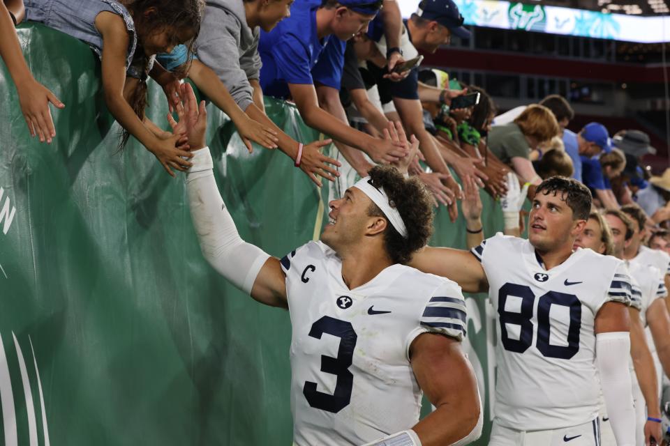 BYU quarterback Jaren Hall (3) high-fives fans after a Cougar victory over USF on Saturday, Sept. 3, 2022, at Raymond James Stadium in <a class="link " href="https://sports.yahoo.com/ncaaf/players/314463" data-i13n="sec:content-canvas;subsec:anchor_text;elm:context_link" data-ylk="slk:Tampa;sec:content-canvas;subsec:anchor_text;elm:context_link;itc:0">Tampa</a>, Fla. | Robert W. Grover,